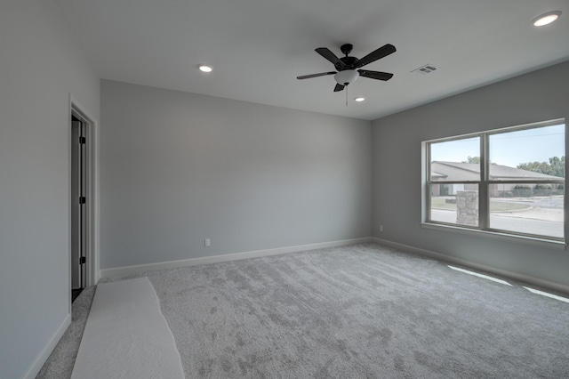 unfurnished room with ceiling fan and light colored carpet