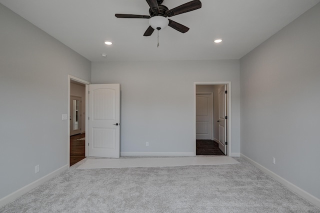 unfurnished bedroom with light carpet and ceiling fan