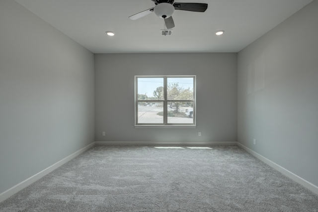 unfurnished room featuring light colored carpet and ceiling fan