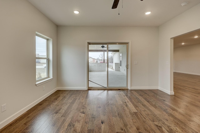 unfurnished room with ceiling fan and dark hardwood / wood-style floors