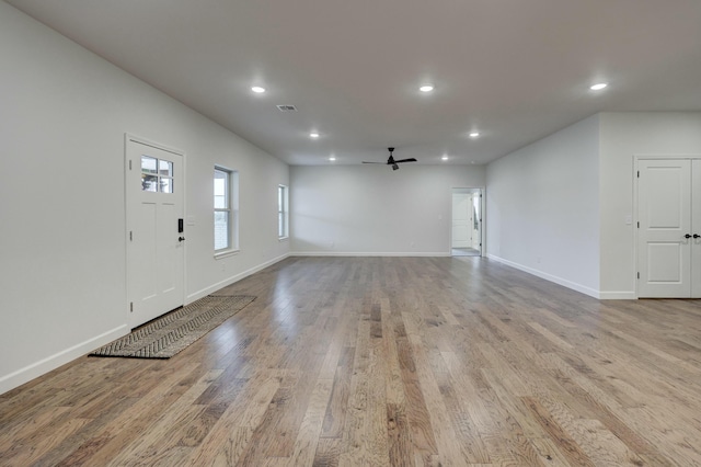 interior space with ceiling fan and light hardwood / wood-style floors