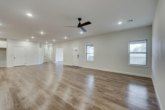 unfurnished living room with hardwood / wood-style floors and ceiling fan