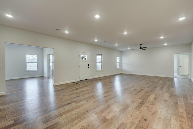 unfurnished living room with ceiling fan and light hardwood / wood-style floors