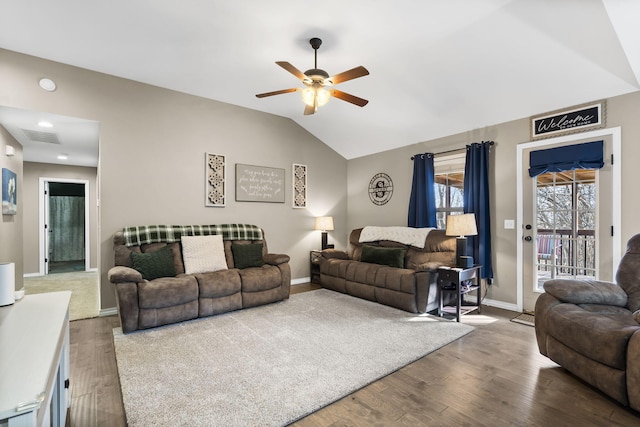 living room featuring hardwood / wood-style floors, lofted ceiling, and ceiling fan