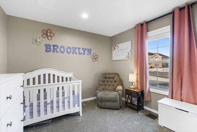 carpeted bedroom with a crib