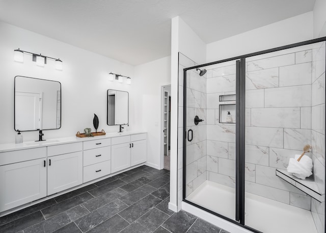 bathroom featuring vanity and a shower with shower door