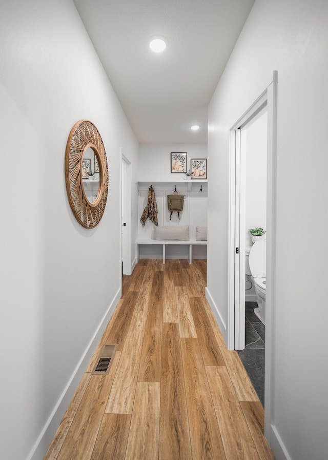 corridor with wood-type flooring