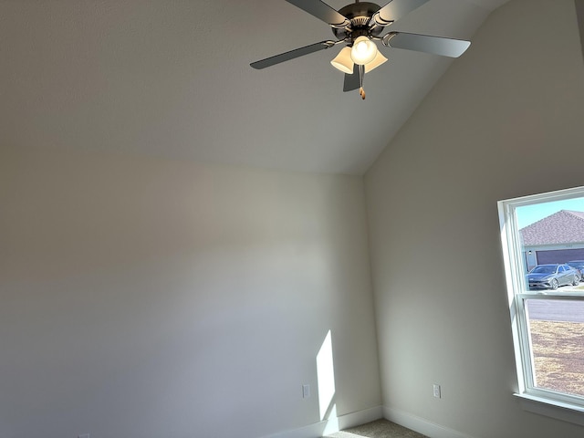 carpeted spare room featuring ceiling fan and lofted ceiling