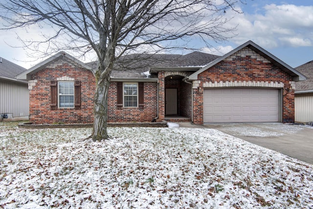 single story home featuring a garage, a shingled roof, brick siding, and concrete driveway