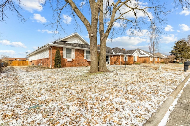 single story home featuring brick siding and fence