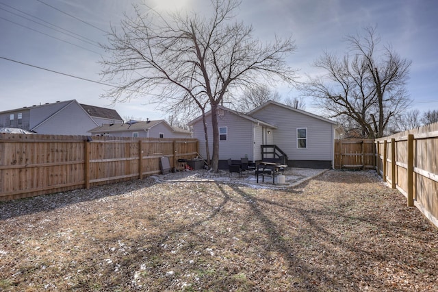 back of property with a fenced backyard