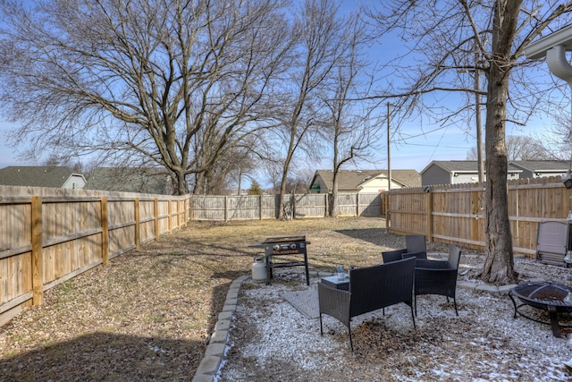 view of yard featuring an outdoor fire pit and a fenced backyard