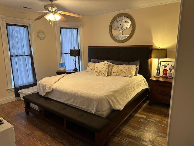 bedroom with dark wood-style flooring, visible vents, ceiling fan, and baseboards