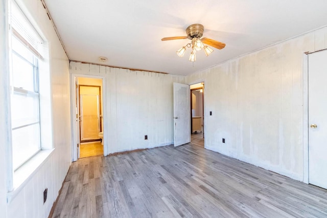 spare room featuring light wood-type flooring and a ceiling fan