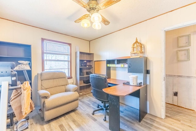 office area featuring crown molding, a ceiling fan, and wood finished floors