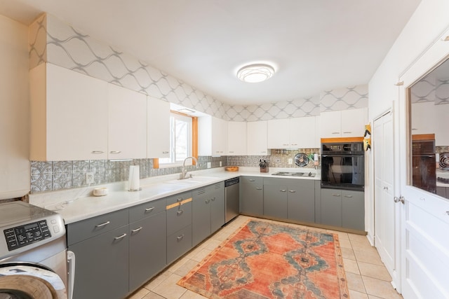 kitchen featuring white cabinets, dishwasher, washer / clothes dryer, light countertops, and black oven