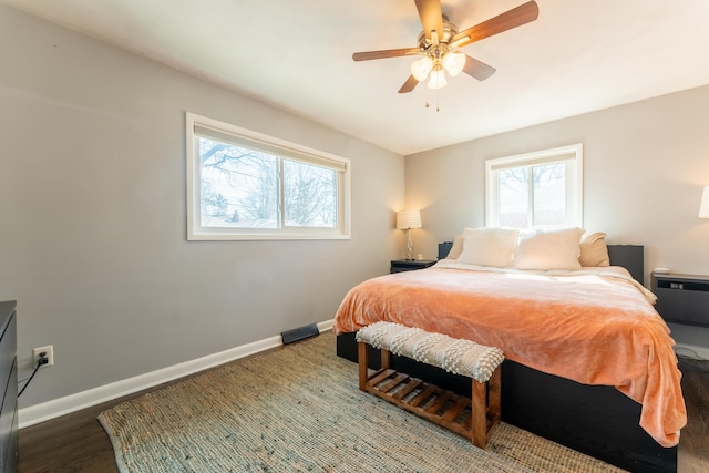 bedroom with ceiling fan, baseboards, and wood finished floors