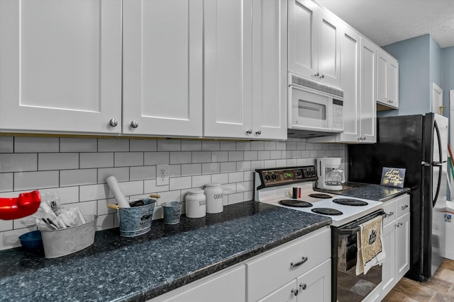 kitchen with tasteful backsplash, dark countertops, white appliances, and white cabinets