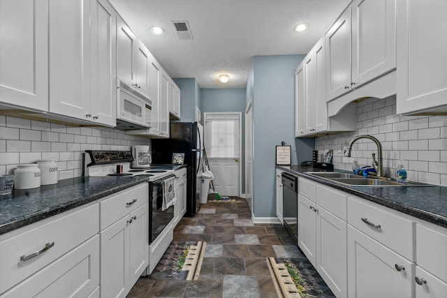 kitchen featuring a sink, visible vents, white cabinetry, baseboards, and black appliances