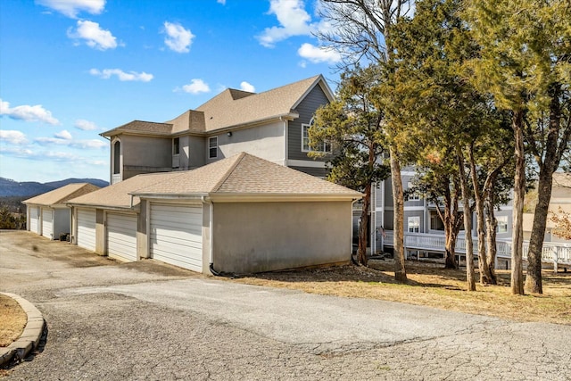 view of front of house featuring a shingled roof and stucco siding