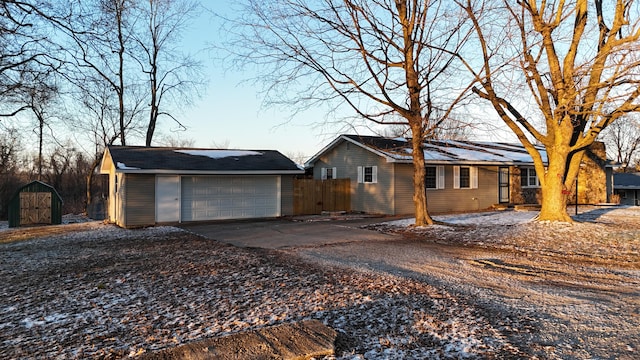 view of front of house with a detached garage and fence