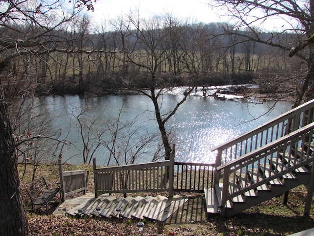 deck featuring a water view and stairs