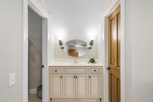 bathroom with a textured ceiling and vanity