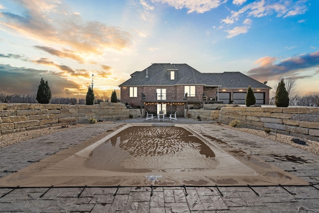 back of property with a patio and brick siding