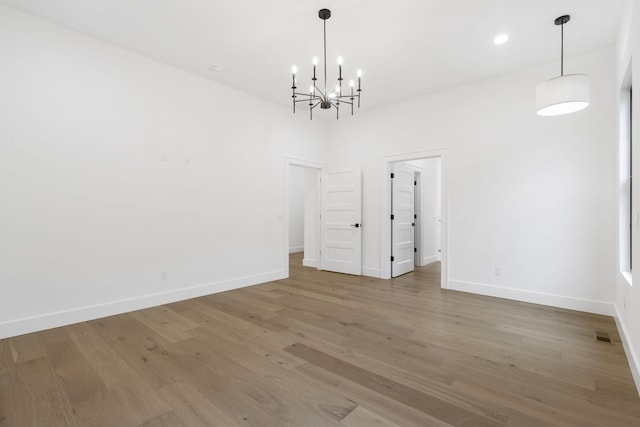 unfurnished dining area featuring wood finished floors, visible vents, and baseboards