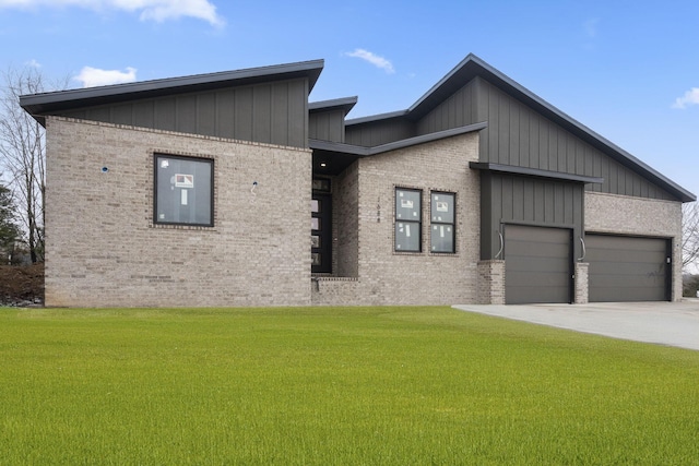 view of front of home with a garage, concrete driveway, a front lawn, and brick siding