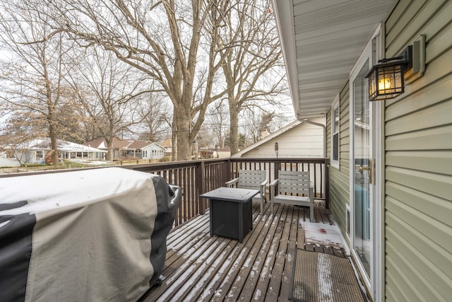 wooden deck featuring a grill and a residential view