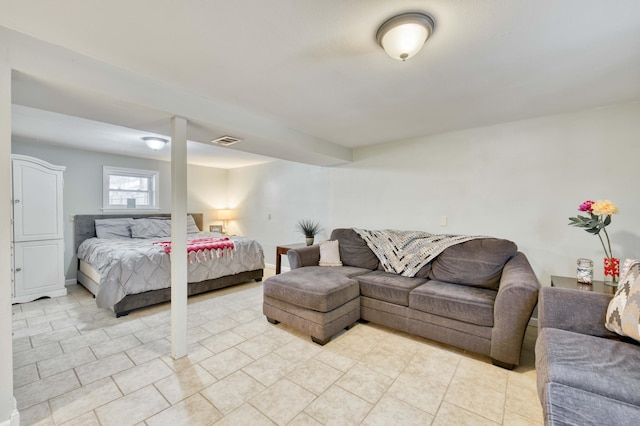 bedroom featuring visible vents, baseboards, and light tile patterned floors