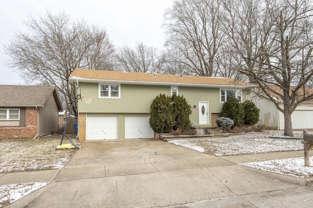 view of front of house featuring a garage, brick siding, and driveway