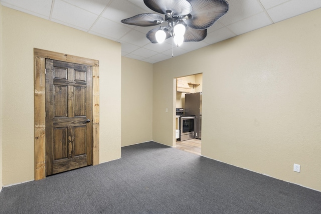 unfurnished room with a ceiling fan, a paneled ceiling, and carpet