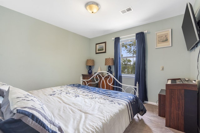 bedroom featuring carpet flooring, visible vents, and baseboards