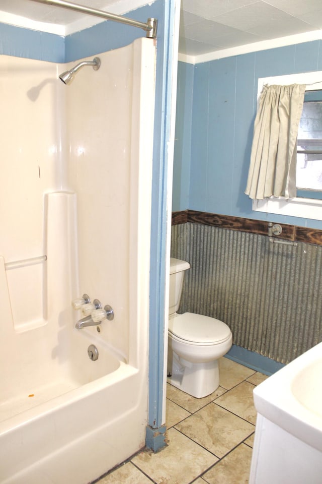 bathroom with toilet, vanity, bathing tub / shower combination, and tile patterned floors