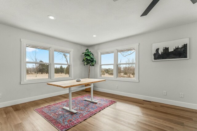 home office with visible vents, baseboards, wood finished floors, and recessed lighting