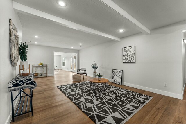 sitting room with recessed lighting, baseboards, beamed ceiling, and wood finished floors