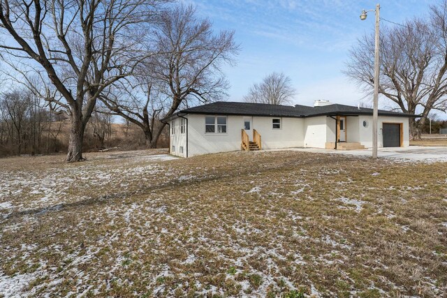 view of front of home with a garage, driveway, brick siding, and entry steps