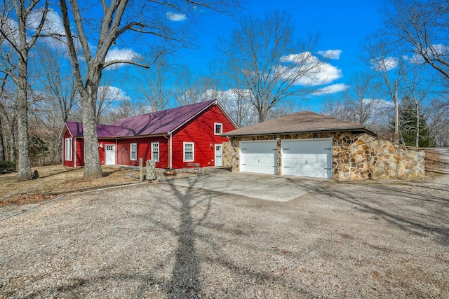 view of front of home featuring a garage and stone siding