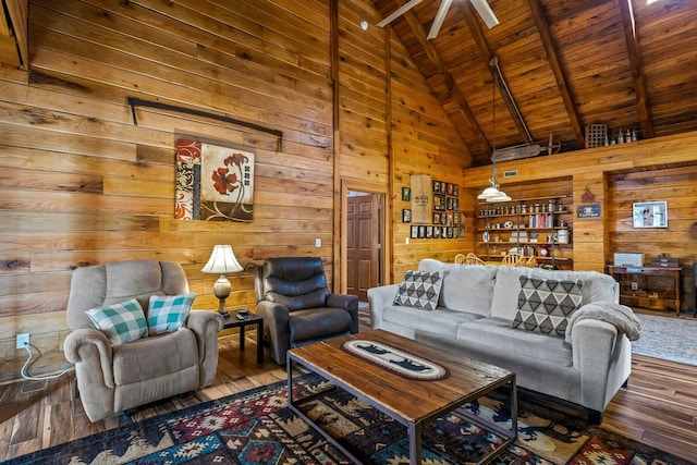 living room featuring high vaulted ceiling, wooden ceiling, wooden walls, wood finished floors, and beamed ceiling