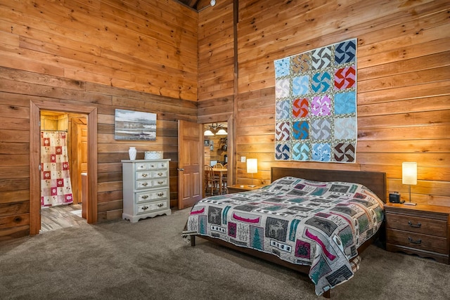 carpeted bedroom with a high ceiling and wooden walls