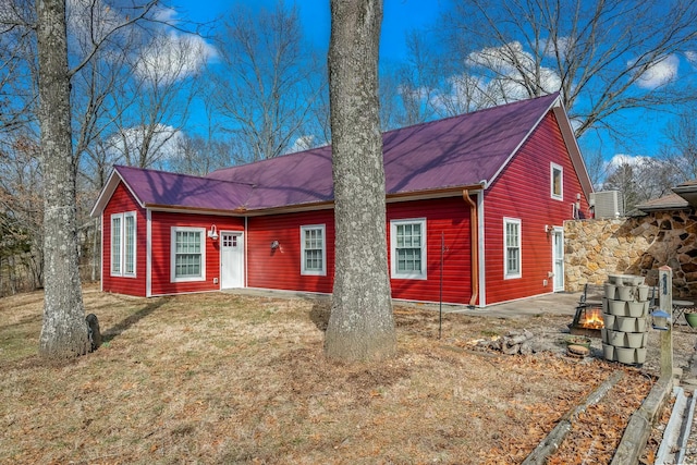 view of front of property with a front lawn and central AC unit