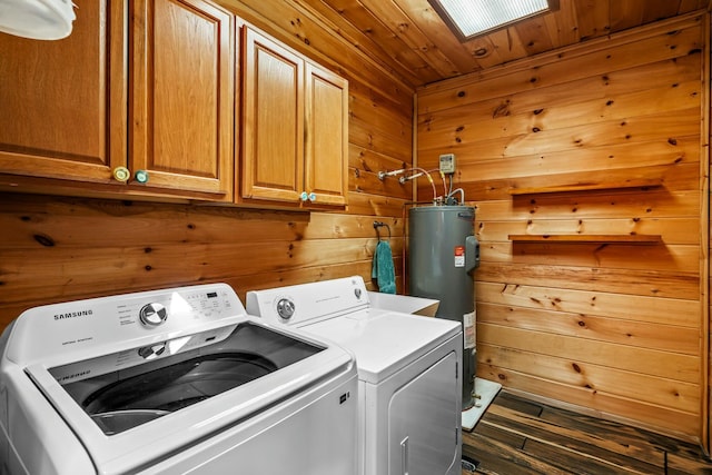 washroom with cabinet space, wooden walls, wood ceiling, electric water heater, and washer and dryer