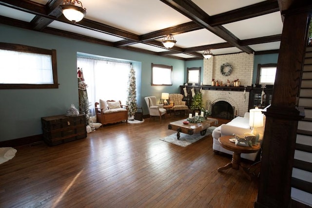 living area with beam ceiling, a fireplace, dark wood-type flooring, coffered ceiling, and baseboards