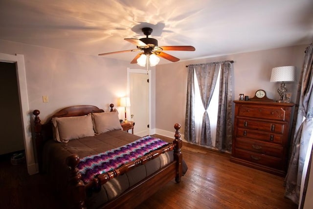 bedroom featuring dark wood-style floors, baseboards, and a ceiling fan