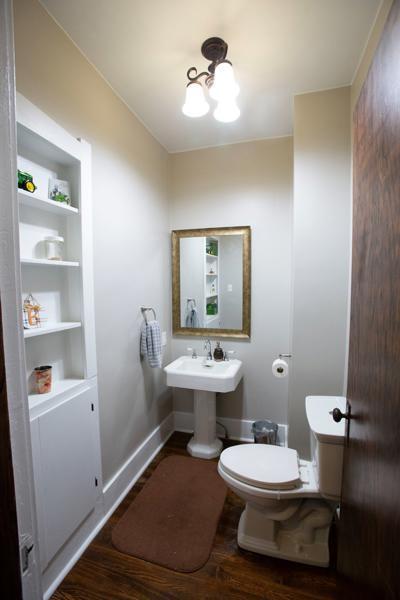 bathroom featuring a chandelier, wood finished floors, toilet, and baseboards