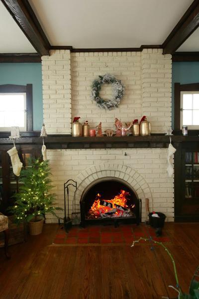 interior details with a brick fireplace, beam ceiling, and wood finished floors