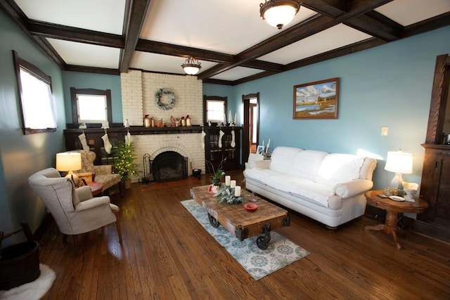 living room with dark wood-style floors, a fireplace, coffered ceiling, and beamed ceiling