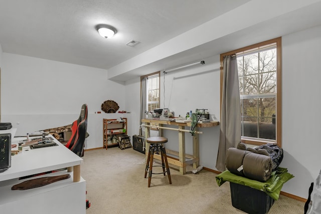 home office featuring light colored carpet, visible vents, and baseboards